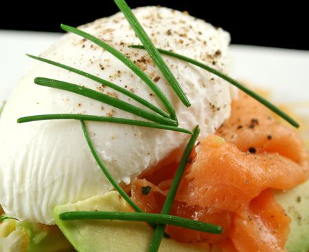 Appetizer of avocado with smoked salmon with poached eggs