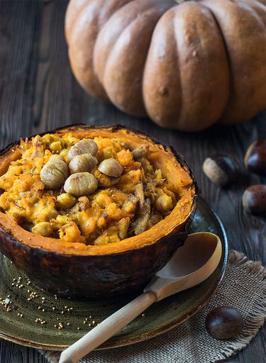 Baked turkey with chestnuts, chickpeas, curry and pumpkin in a pumpkin