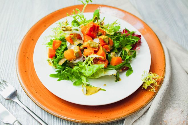 Green salad with baked pumpkin, goat cheese and dressing seafood