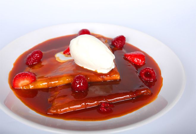 Pancakes in the caramel and citrus sauce with strawberries