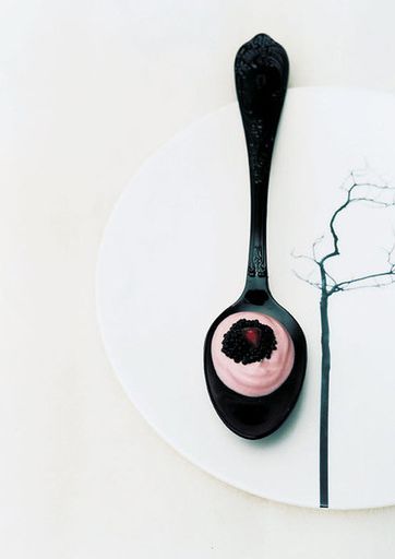 Goat cheese with black caviar on a spoon