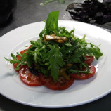 Salad with chanterelle mushrooms on a bed of tomato Salad with chanterelle mushrooms on a bed of tomato