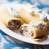Pancakes stuffed with chicken, mushrooms and cheese sauce Pancakes stuffed with chicken, mushrooms and cheese sauce