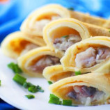 Russian pancakes with herring and onions