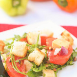 Arugula salad, tomatoes and feta cheese with pine nuts